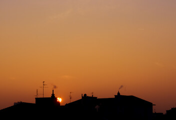 Minimalist sunset view, orange clear sky, city buildings horizon, copy space for banner, lyrics,...