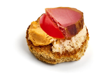Spanish food tapas. Toast with fresh goat cheese and smoked serrano meat , isolated on white...