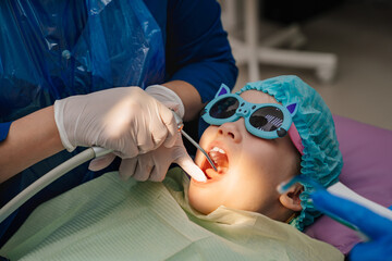 oral hygiene and treatment of the child. teeth cleaning at stomatologist