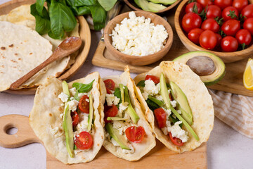 vegan tacos with avocado and tomatoes.