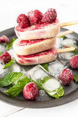 Homemade Raspberry Banana Popsicles with Coconut Milk. Homemade and healthy ice cream. Vegan ice cream with fresh fruit and mint leaves