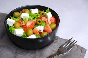 A fresh vegetable salad. Salad with olives, feta cheese, cucumbers, tomatoes.