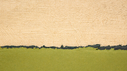 abstract paper landscape in green and beige pastel tones created from sheets of handmade textured paper