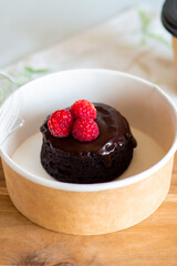 Dessert delivery in a carton box.Chocolate fondant with you.Delivery of chocolate dessert.Fondant with you.Cupcake with fondant lava in a box.Warm chocolate dessert.Takeaway sweet.Cupcake with berries