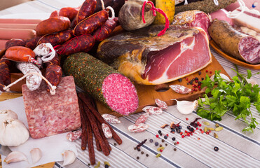 Variety of meats, sausages and mince with herbs on table
