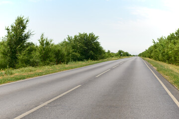 An asphalt road outside the city. View from the car.