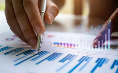 Business asian woman working with financial data hand using calculator and laptop to calculate investment results, Business reports financial and accounting concept,