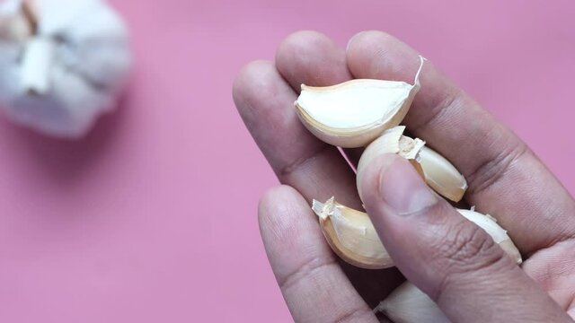 close up pf garlic on palm of hand 