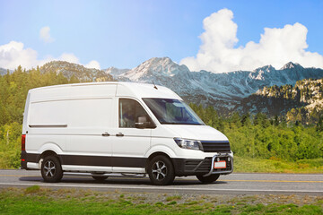 White Delivery Van Courier Service at Speed in beautiful road landscape.