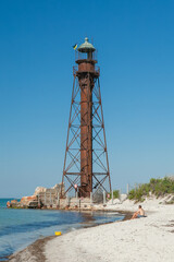 Fototapeta na wymiar lighthouse by the sea in summer
