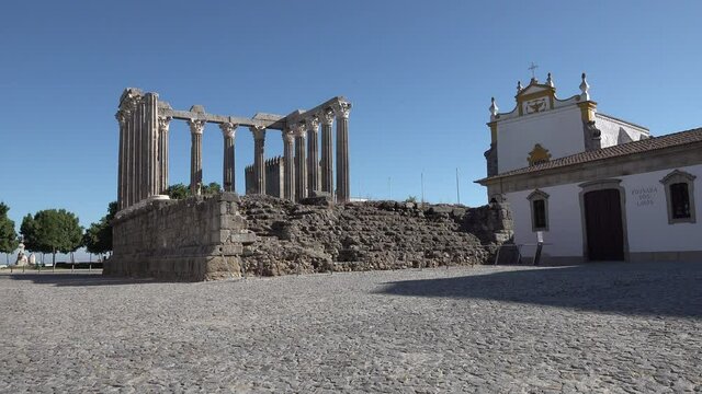 Establishing shot of the well preserved 'Templo Romano', a historic Roman temple in beautiful Evora town in Portugal
