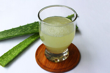 Aloe vera juice and stem on white background
