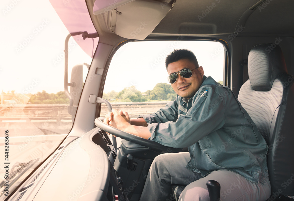 Wall mural semi truck driver wearing sunglasses happy smiling