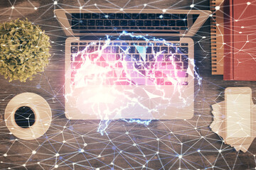 Double exposure of brain drawing hologram over topview work table background with computer. Concept of big data.
