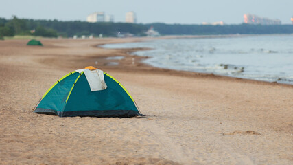 Tent on a sandy beach near water