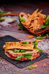 Crispy tacos with salsa on a wooden red background. Mexican food and fast food. High quality photo