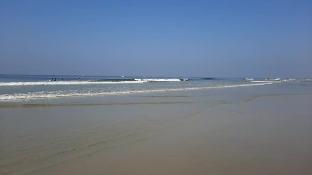 Colva beach in goa, palm tree in beach, tropical beach, blue water and blue sky Arabian sea beach in India, white sand and blue water.