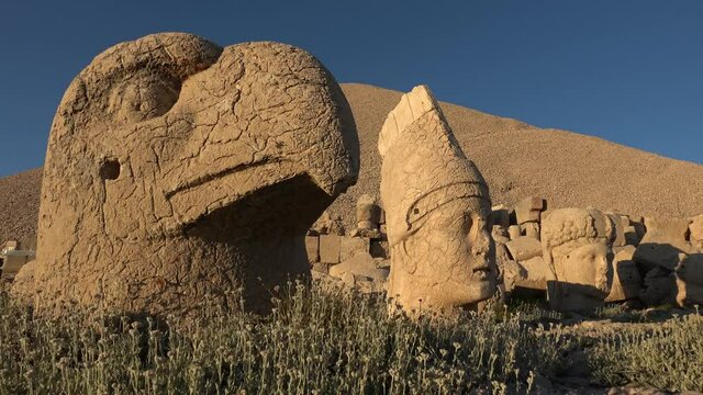 Mount Nemrut, Adiyaman, Turkey - 17th of June 2021: 4K Eagle stone head and burial mound 

