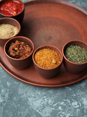 Georgian spices in clay jars on a plate.
