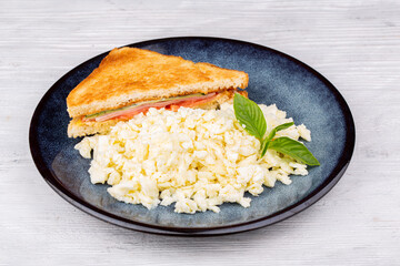 European breakfast, toast with ham, cheese, tomato, lettuce, mayonnaise, egg, milk, butter, salt