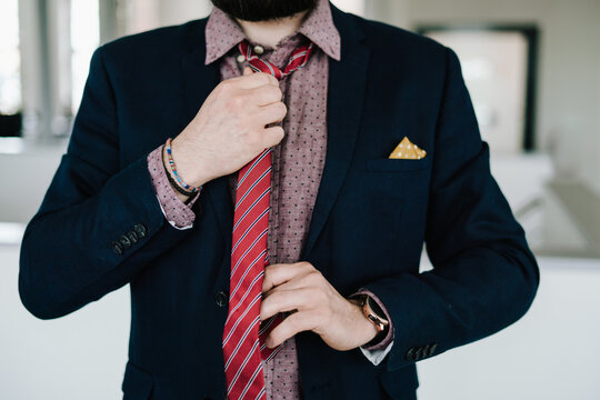 Business Man straightening  red tie