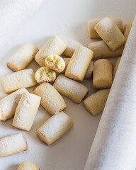 Sweet sugar powdered homemade cookies on white background, selective focus