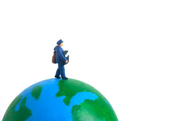 Miniature people toys conceptual photography. Global, international delivery service. Postman, courier standing above earth globe.