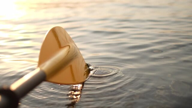 Kayak paddle water drops.Yellow paddle close-up.