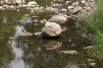 Naklejka na ściany i meble stones on a river bed