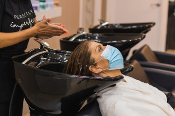 woman getting hair wash in hair salon