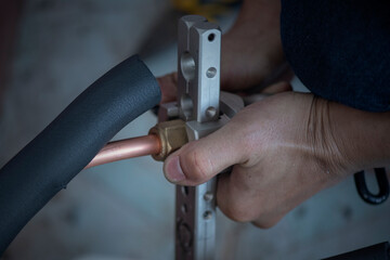 Image of Air conditioner technician is connecting pipes to bring home air conditioners.,air conditioning equipment.