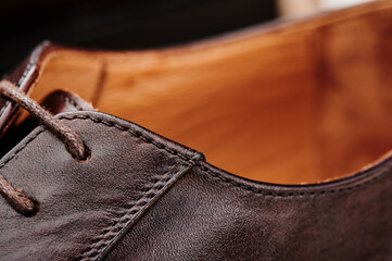 Brown leather men's shoes made of genuine leather in classic style close-up. High quality photo