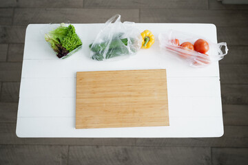 Fresh vegetables and lettuce on white wooden kitchen table