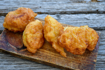 Traditional Bulgarian home made deep fried  patties  covered with sugar  оn rustic backgroud.Mekitsa or Mekica,  on wooden  rustic  background. Made of kneaded dough that is deep fried 