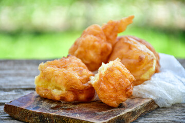 Traditional Bulgarian home made deep fried  patties  covered with sugar  оn rustic backgroud.Mekitsa or Mekica,  on wooden  rustic  background. Made of kneaded dough that is deep fried 
