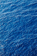Obraz premium View on blue sunlit sea at summer. Natural background.