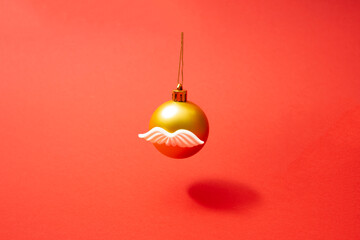Disguise christmas ball with mustache.