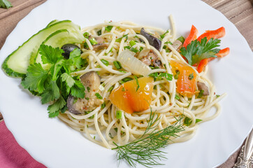 Vegetable pasta with stewed eggplant and pepper on a white plate close-up
