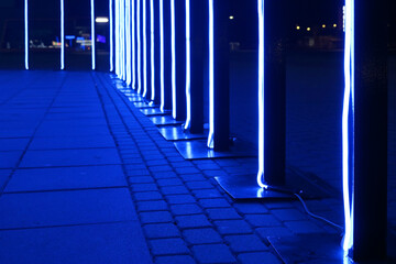 Blue led neon flexible strip light glowing in dark light.