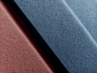 Brown and pastel blue sponge foam surface texture background. piles of thick sponge foam in a...