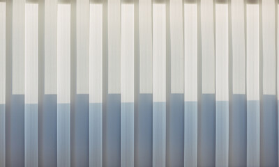 Abstract geometric vertical lines white and gray gradient color. Repeating pattern, background texture, design of striped lines. Blinds illuminated by the sun, close-up.