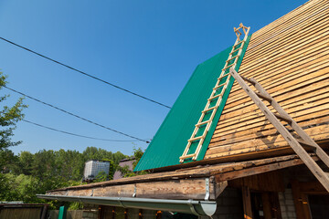 Construction industry. Timber framework of greenhouse roof trusses with scaffold on a building...