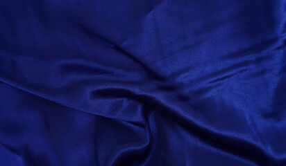 Deep blue silk satin fabric. Elegant abstract background with copy space for your design.
