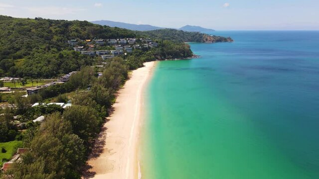 4K Aerial Side View of Nai Thon Beach in Phuket. Beach, sea and sand. Drone view of a beautiful white tropical sand beach on a summer day in Thailand. Top view empty and clean beach. Phuket, Thailand