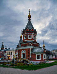 Fototapeta na wymiar Alexander Nevskiy Chapel in Yaroslavl in Russia.This small chapel was built in 1892 in typical Russian style featuring intricate brickwork and a tent-roofed belfry. 