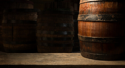 Pouring red wine into the glass against wooden background