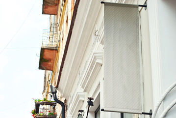 Rectangular sign on the building. Copy space and space for text. Mockup for design. Blank template for advertising.