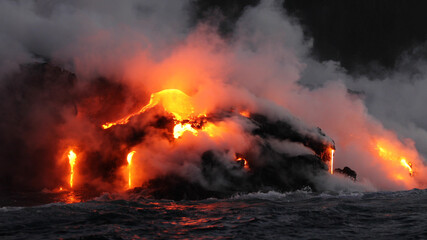 Lava running in the ocean from volcanic lava eruption on Big Island Hawaii. Seen from lava boat...