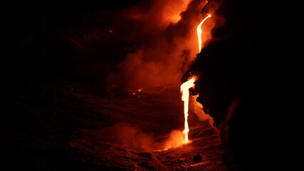 Lava flowing into the ocean from volcano lava eruption on Big Island Hawaii. Lava stream flowing in...