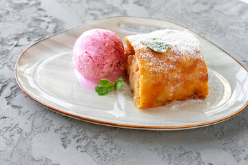 Piece of apple pie served with ice cream
